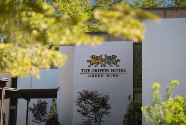 Griffin Hotel signage view through the leaves